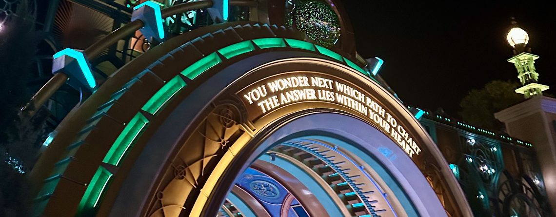 Epic Universe portal with sign saying "you wonder next what path to chart the answer lies within you heart"