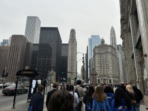 students walking in downtown Chicago with the tall buildings