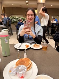 student enjoying breakfast at the hotel