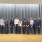 Students posing on stage smiling